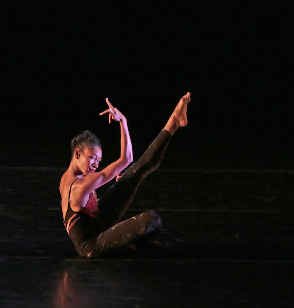 Kristin Foote looks out to the audience as she sits on the stage in profile